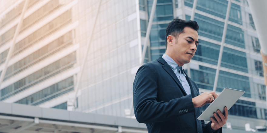 Investor examining the benefits of investing in hard money construction loans on a tablet